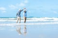 Asian Lifestyle senior couple dancing on the beach happy and relax time.